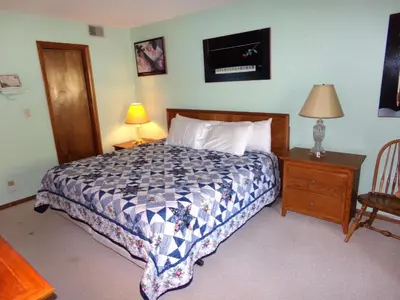 a bedroom with a bed and a lamp and a chair at Mountainside 2 Bed 2 Bath MSBD in Frisco