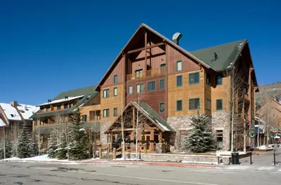 a large wooden building with a gambrel at Arapahoe Lodge 1 Bed 2 Bath ALJD in Keystone
