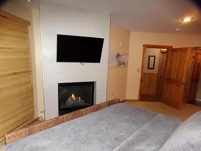 a bedroom with a fireplace with a television on the wall at Buffalo Lodge 3 Bed 3 Bath BLCD3 in Keystone
