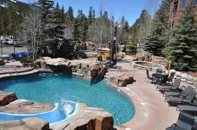 a pool in a resort with chairs and trees at Springs 2 Bed3 Bath plus Murphy SPDW in Keystone