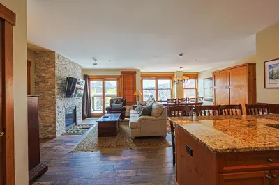 a kitchen and living room with a stone fireplace at Springs 2 Bed3 Bath plus Murphy SPDW in Keystone