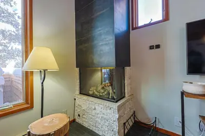 a fireplace in a living room with a table and a lamp at Tennis Townhome 2 Bd 25 Ba TTMR in Keystone