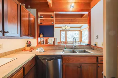 a kitchen with wooden cabinets and a stainless steel sink at Tennis Townhome 2 Bd 25 Ba TTMR in Keystone