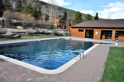 a swimming pool in a yard with a house at Tennis Townhome 2 Bd 25 Ba TTMR in Keystone