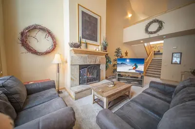 a living room with a couch and a fireplace at Ironwood 2986 by SummitCove Lodging in Keystone