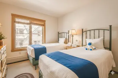 a bedroom with two beds and a teddy bear on the bed at Black Bear 8052 by SummitCove Lodging in Keystone