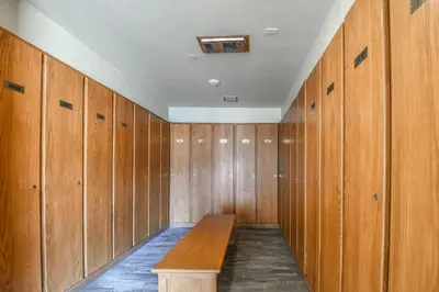 a locker room with a wooden bench in it at Lakeside 1481 by SummitCove Lodging in Keystone