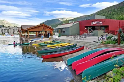 a bunch of boats are lined up on the water at Lakeside 1481 by SummitCove Lodging in Keystone