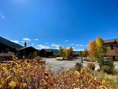 a street in a small town with trees and buildings at Antlers Gulch 501 by SummitCove Lodging in Keystone