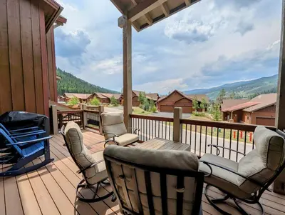 a deck with chairs and a table and a grill at Alders 854 By SummitCove Lodging in Keystone