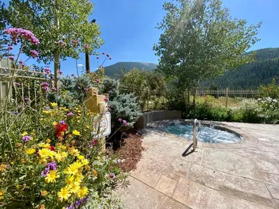 a garden with a small pond with flowers at Alders 854 By SummitCove Lodging in Keystone