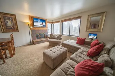 a living room with a couch and a fireplace at Mall 1421 by SummitCove Lodging in Keystone