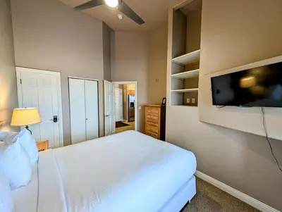 a bedroom with a bed and a flat screen tv at Hidden River Lodge 5981 by SummitCove Lodging in Keystone