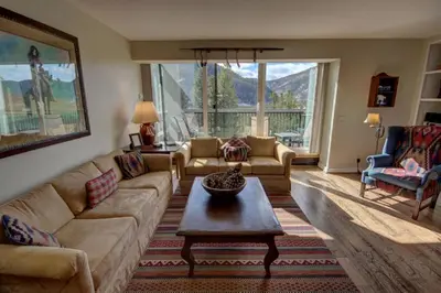 a living room with a couch and a coffee table at Saints John 2526 by SummitCove Lodging in Keystone
