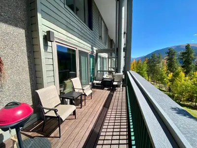 a balcony with chairs and a grill on a house at Saints John 2526 by SummitCove Lodging in Keystone