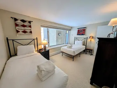 a bedroom with two beds and a window at Saints John 2526 by SummitCove Lodging in Keystone