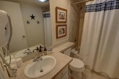 a bathroom with a sink and a toilet and a shower at Saints John 2526 by SummitCove Lodging in Keystone