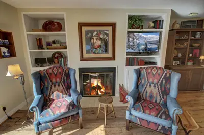two chairs in a living room with a fireplace at Saints John 2526 by SummitCove Lodging in Keystone