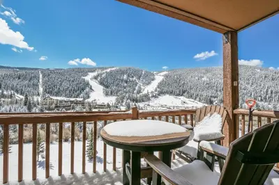 a balcony with a table and chairs and a view at Tenderfoot Lodge 2673 by SummitCove Lodging in Keystone