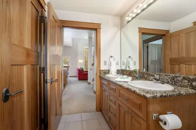 a bathroom with a sink and a large mirror at Seasons 1850 in Keystone