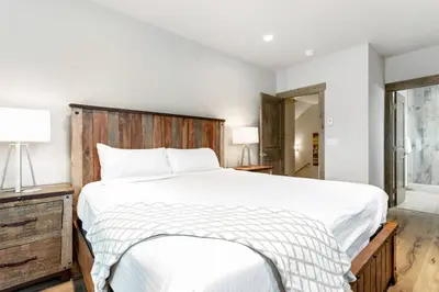 a bedroom with a large bed with a wooden headboard at Treehouse Village 323 in Silverthorne