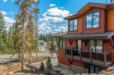 a home with a red house with a balcony at Treehouse Village 323 in Silverthorne