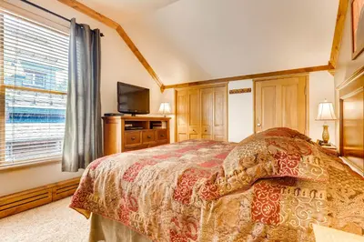 a bedroom with a bed and a tv and a window at Spacious 1Br Condo-River Run Village-Hot Tub & Kids Ski Free Condo in Keystone