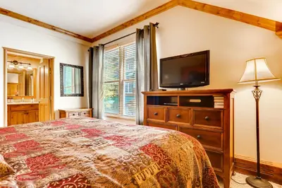 a bedroom with a bed and a flat screen tv at Spacious 1Br Condo-River Run Village-Hot Tub & Kids Ski Free Condo in Keystone