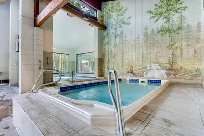a swimming pool in a house with a spa at Spacious And Modern 2Br Premier- The Pines- Kids Ski Free Condo in Keystone
