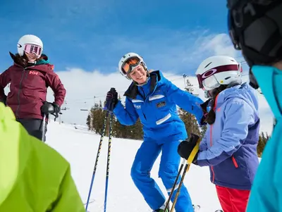 a group of people on skis in the snow at Spacious And Modern 2Br Premier- The Pines- Kids Ski Free Condo in Keystone