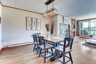 a dining room with a table and chairs at Spacious And Modern 2Br Premier- The Pines- Kids Ski Free Condo in Keystone