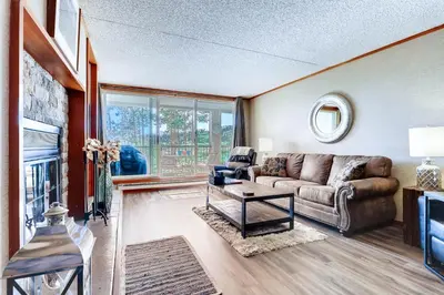 a living room with a couch and a fireplace at Spacious And Modern 2Br Premier- The Pines- Kids Ski Free Condo in Keystone