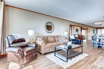 a living room with a couch and a table at Spacious And Modern 2Br Premier- The Pines- Kids Ski Free Condo in Keystone