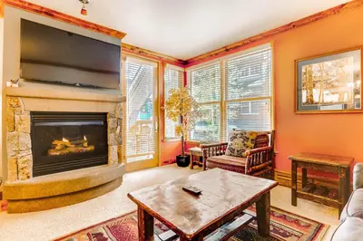 a living room with a fireplace and a flat screen tv at Updated 1Br Premier Condo At Black Bear Lodge- Kids Ski Free Condo in Keystone