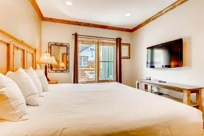 a bedroom with a large white bed and a television at Updated 1Br Premier Condo At Black Bear Lodge- Kids Ski Free Condo in Keystone