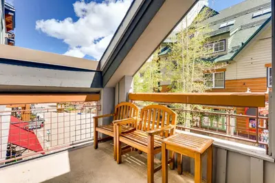 a balcony with two wooden chairs and a table at Updated 1Br Premier Condo At Black Bear Lodge- Kids Ski Free Condo in Keystone