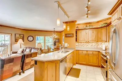 a kitchen with wooden cabinets and a counter top at Heart Of River Run & Spacious 2Br Premier Condo in Keystone