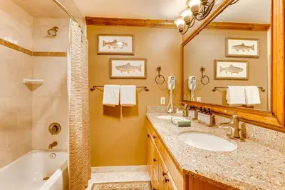 a bathroom with a tub and a sink and a mirror at Heart Of River Run & Spacious 2Br Premier Condo in Keystone