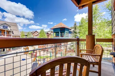 a balcony with a wooden bench and a view of a town at Heart Of River Run & Spacious 2Br Premier Condo in Keystone