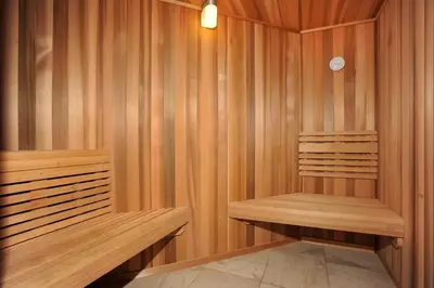 a sauna with wooden walls and two wooden benches at Heart Of River Run & Spacious 2Br Premier Condo in Keystone