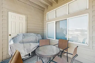 a room with a table and chairs and a window at Bay Club 107 in Frisco