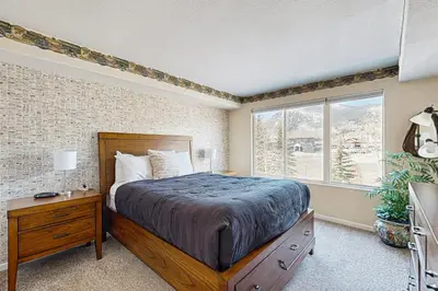a bedroom with a large bed and a window at Bay Club 107 in Frisco