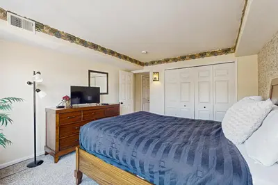 a bedroom with a bed and a tv on a dresser at Bay Club 107 in Frisco