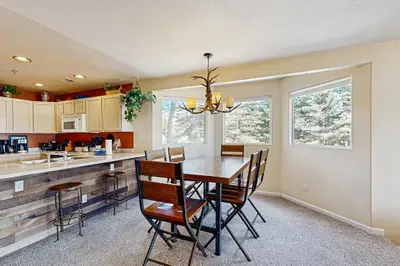 a kitchen with a dining room table and chairs at Bay Club 107 in Frisco