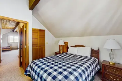 a bedroom with a blue and white checkered bed at Deer Path Escape in Dillon