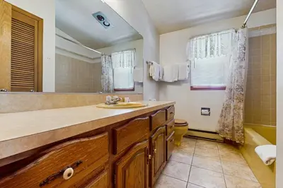 a bathroom with a sink and a large mirror at Deer Path Escape in Dillon