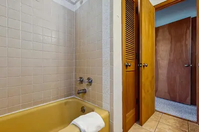 a bathroom with a yellow tub and a shower at Deer Path Escape in Dillon