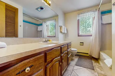a bathroom with a sink and a toilet and a tub at Deer Path Escape in Dillon