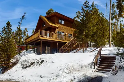 a log cabin in the snow with snow covered at Deer Path Escape in Dillon