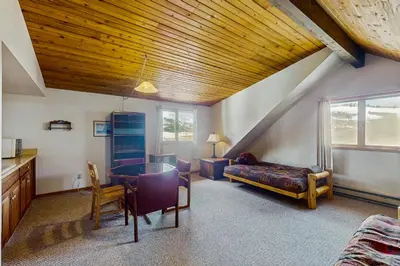a room with a bed and a table and chairs at Deer Path Escape in Dillon